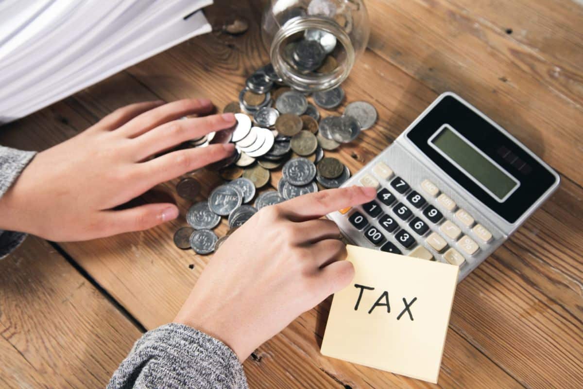 woman-working-calculator-with-tax-coins